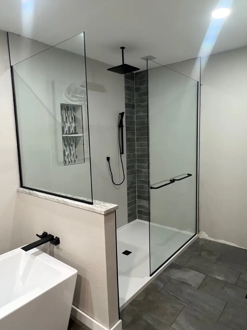 A bathroom with a shower and sink in it