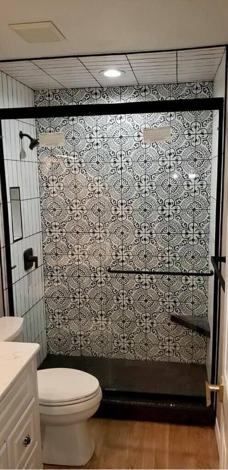 A bathroom with tiled walls and floors.